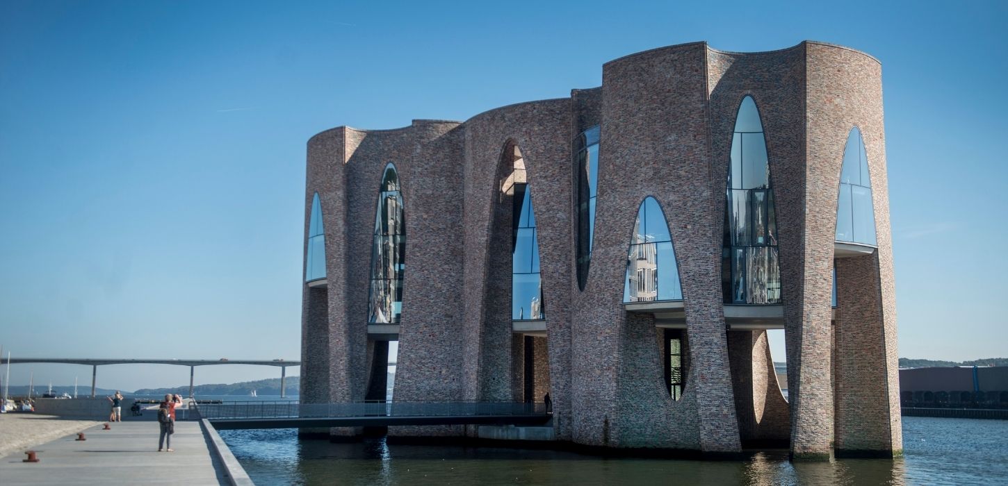 Fjordenhus on a summer day with blue sky and the Vejlefjord Bridge in the background