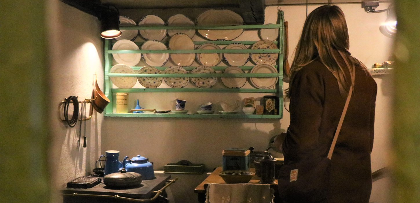 Woman looking around at Museum Give