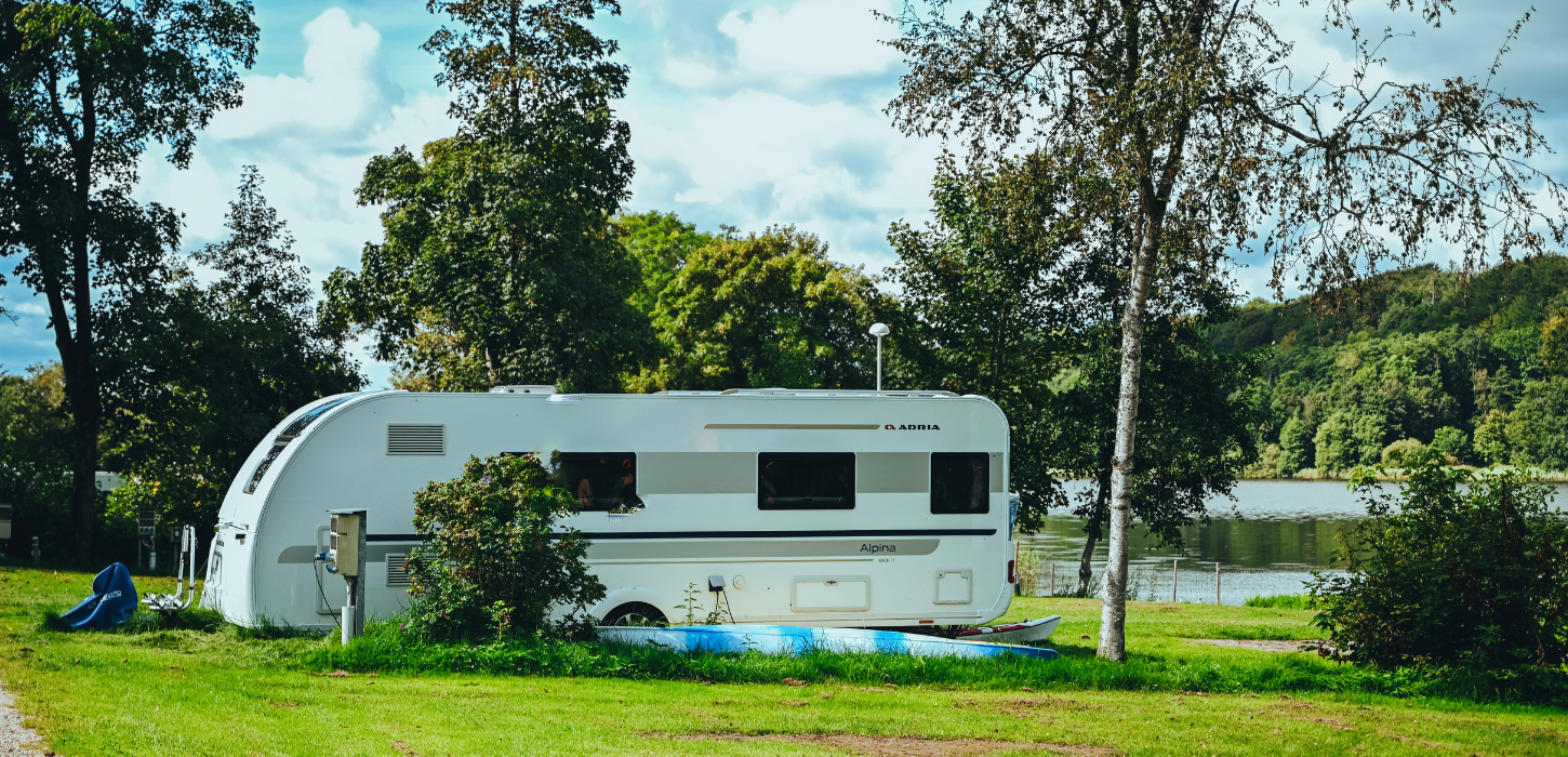 A caravan is parked by Fårup Lake near Jelling